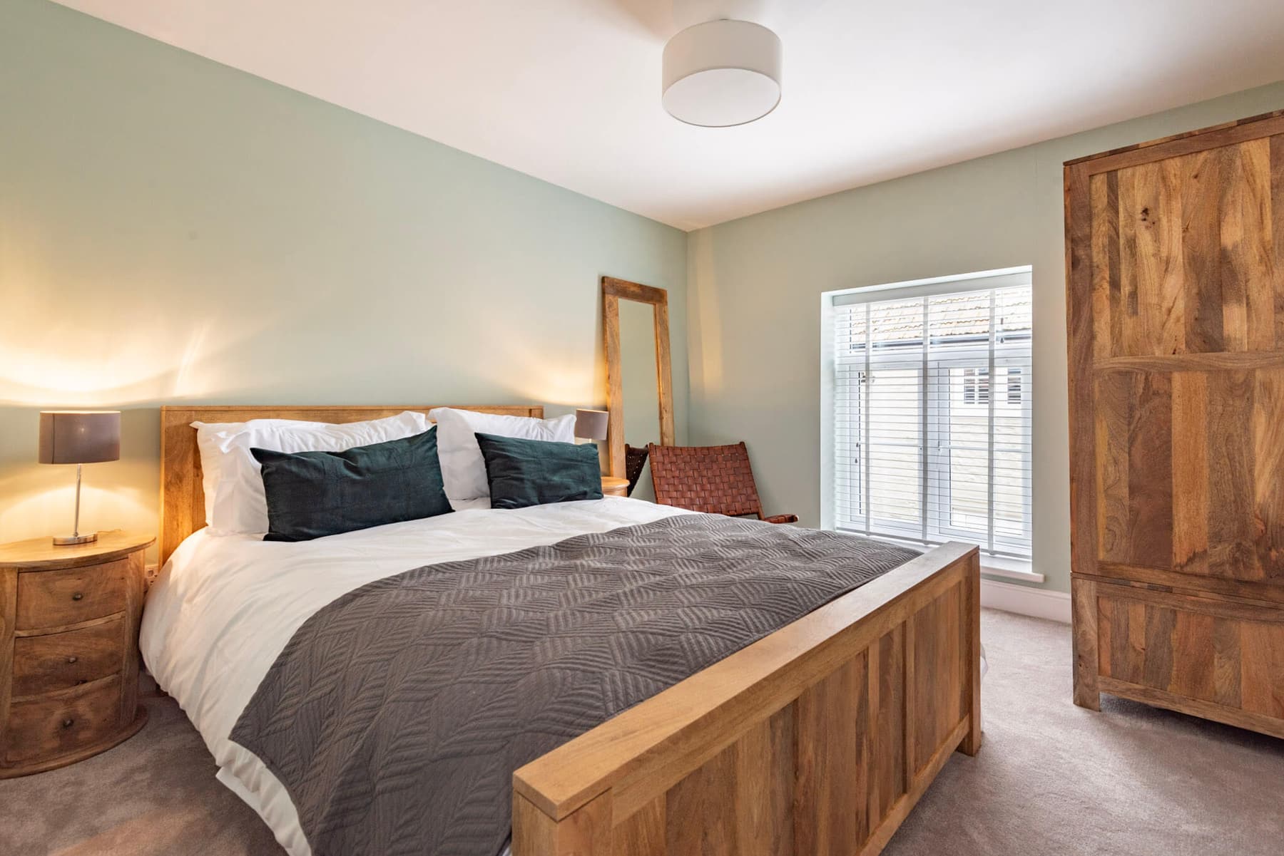 The Thornham Room at South Creek Retreat, its solid mango wood bed and wardrobe