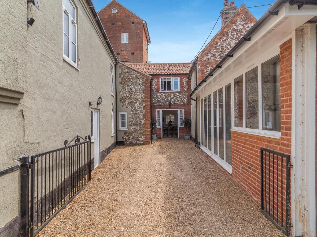 The flint-walled courtyard running along the side of the house