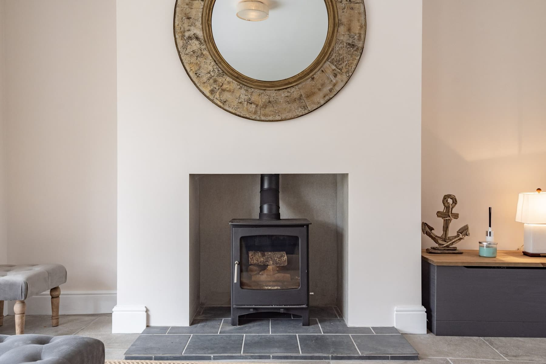 The fireplace and mirror in the lounge at South Creek Retreat
